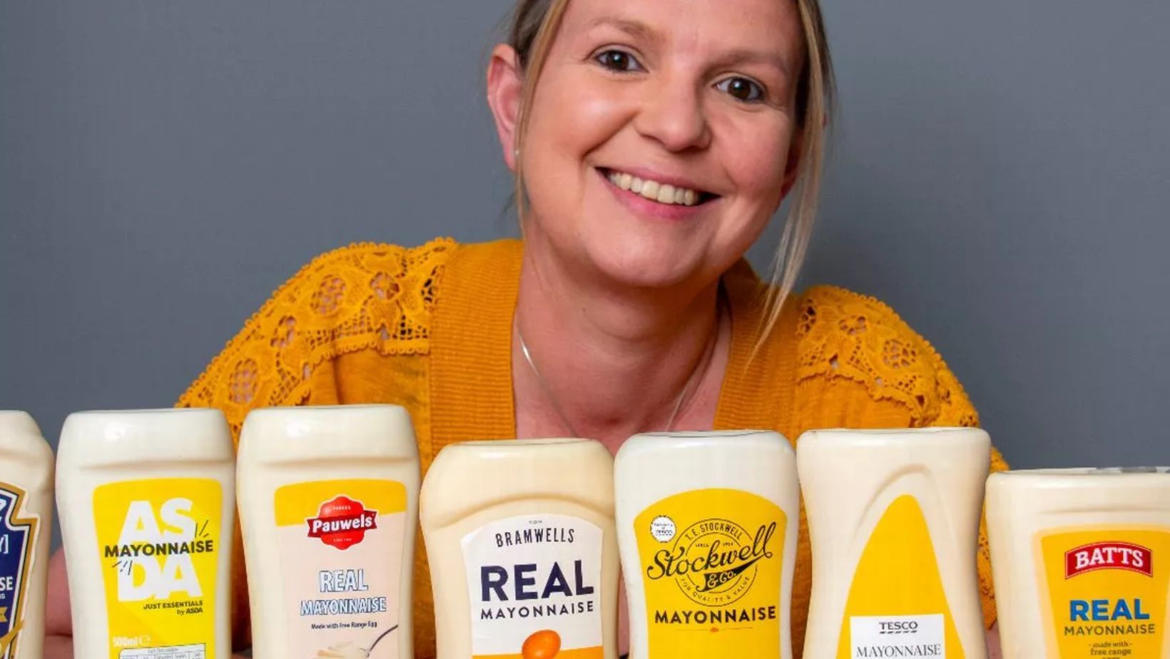 A woman with different types of mayonnaise.