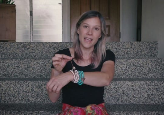 A woman wearing a bead bracelet.