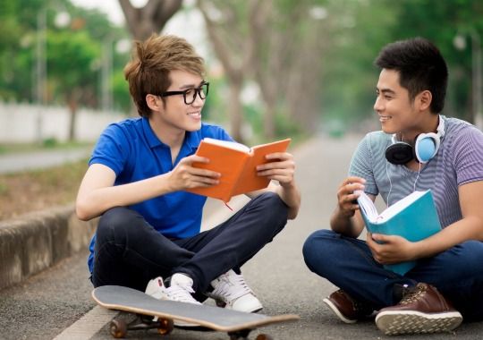 Two men reading books.