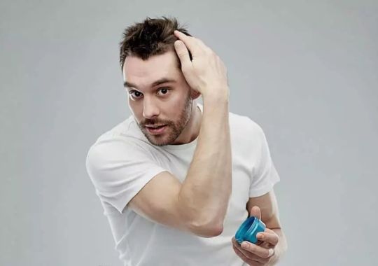 A man waxing his hair.