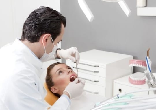 A  woman getting the temporary teeth fillings.