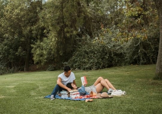 A man and a woman reading a book.