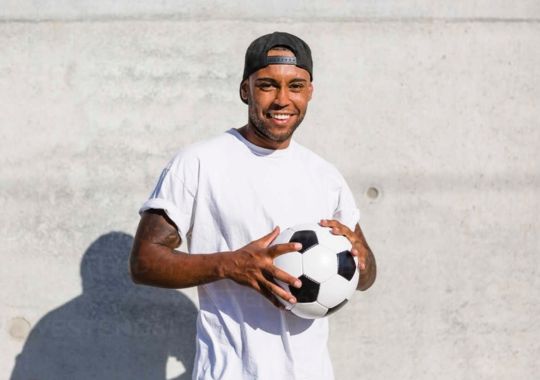 A man holding a soccer ball.