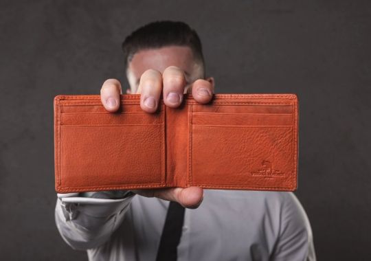 A man holding a wallet.