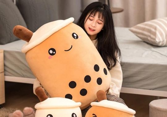 A girl with XL Squishmallows.