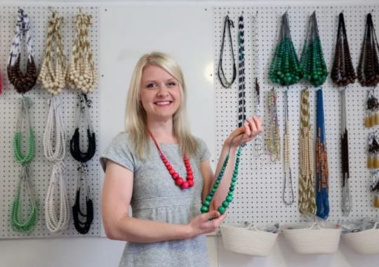 A woman checking out some necklaces.