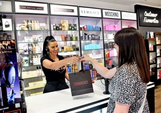 A woman buying perfume.