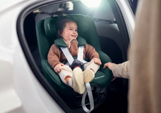 A baby seated in a car seat.