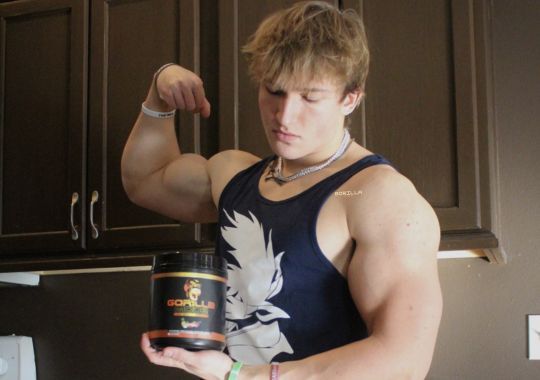 A man with Gorilla Mode Pre-Workout Supplement.