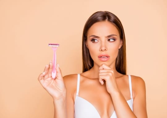 A woman holding a shaving stick.