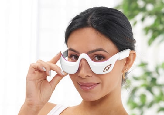 A woman with eye massagers.