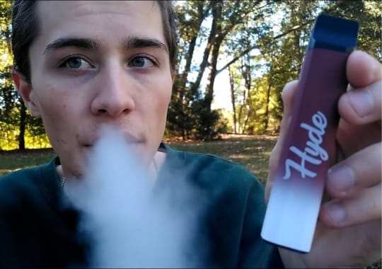 A man holding a disposable hyde.