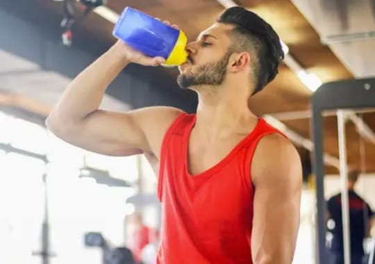 A man drinking supplements.