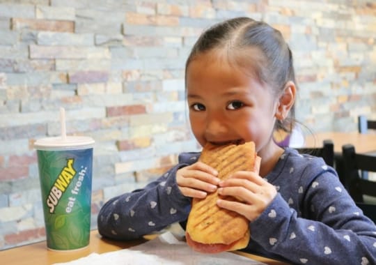 A child eating a healthy subway.