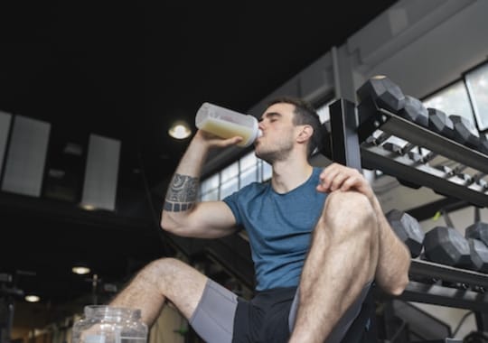 A man drinking clear whey protein.