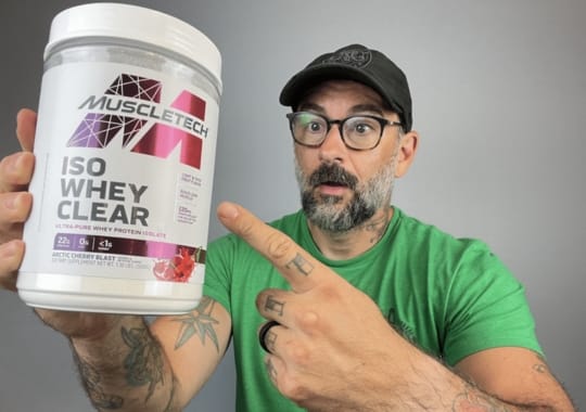 A man showing off a tin of Clear whey protein.