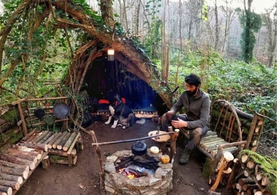 A man preparing food in the woods.