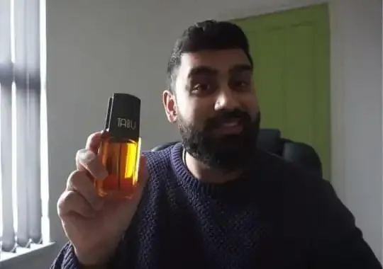 A man with a bottle of tabu perfume.
