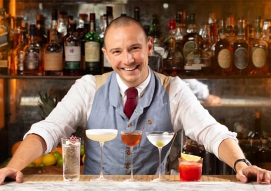 A man with different types of cocktails.