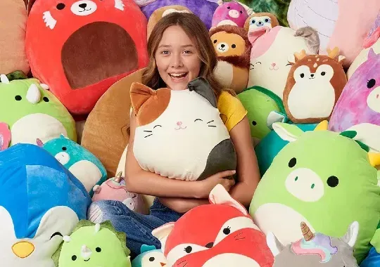 A young girl with squishmallows.