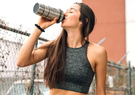 A teen drinking protein shake.