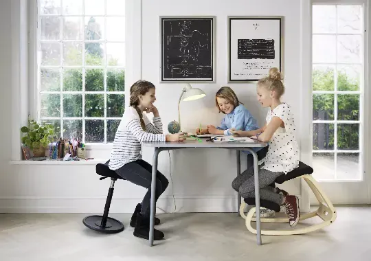 Three kids sitting on different adhd chairs.