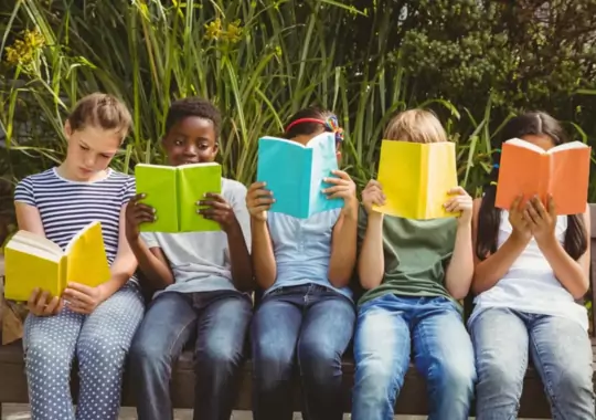 A group of kids reading books.