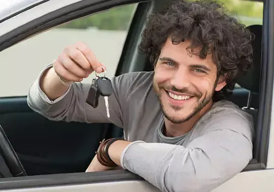 A man showing off car keys.