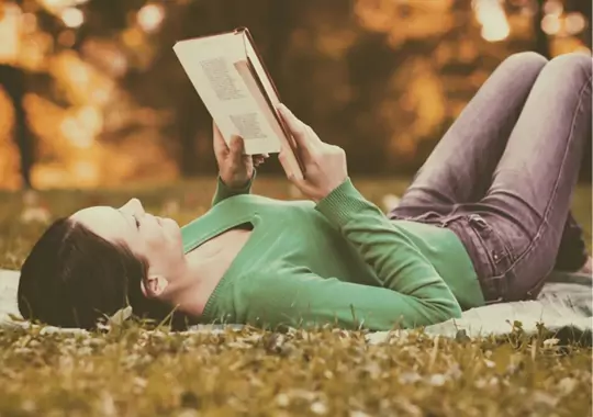 A woman reading a self-love book.