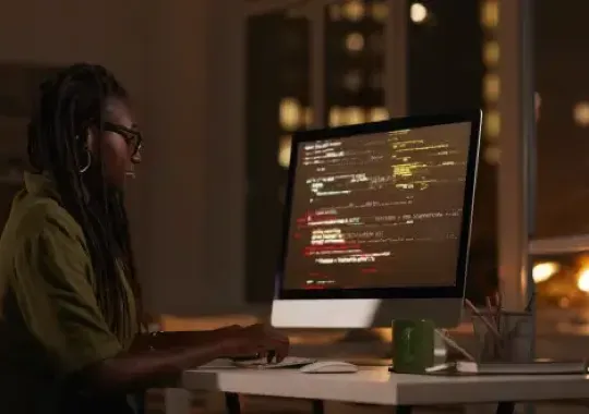 A woman doing cybersecurity on a computer.