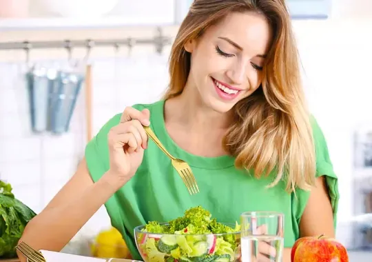 A woman eating a healthy meal.