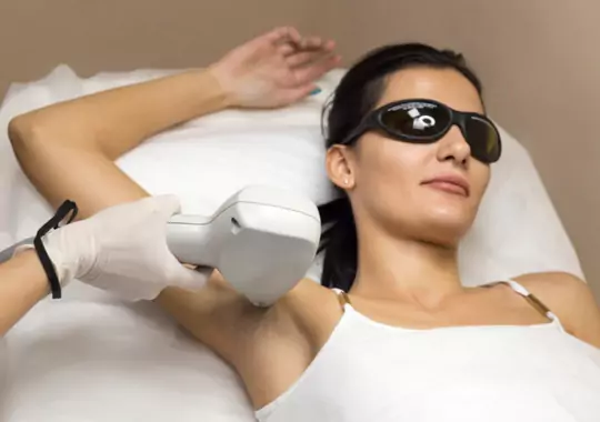 A woman doing underarm laser hair removal.