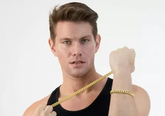 An individual wearing a gold link chain.