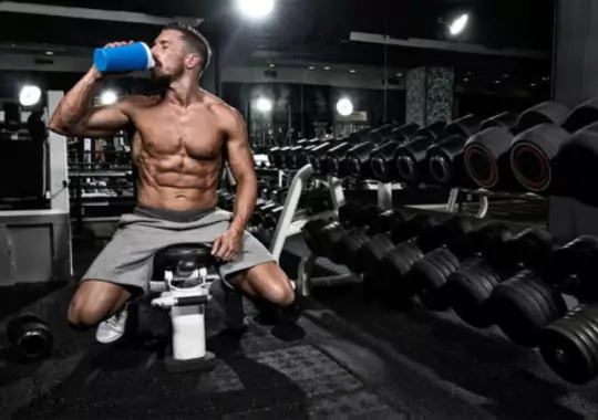 A man drinking C4 pre-workout supplement.