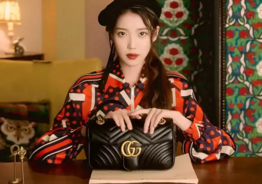 A woman with a gucci purse.