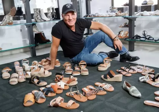 A man displaying different types of shoes.