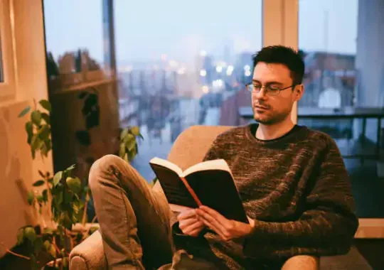 A man reading a parenting book.