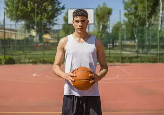 A man holding a basketball.