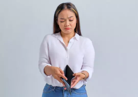 A woman holding a wallet.