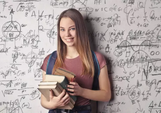 A physics student with study books.