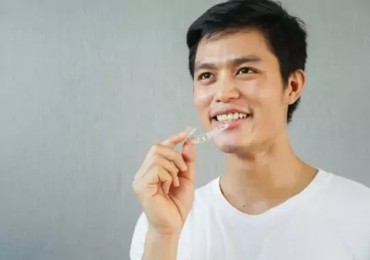 A man holding an Invisalign.