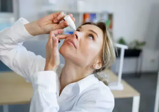A woman putting weed eye drops.