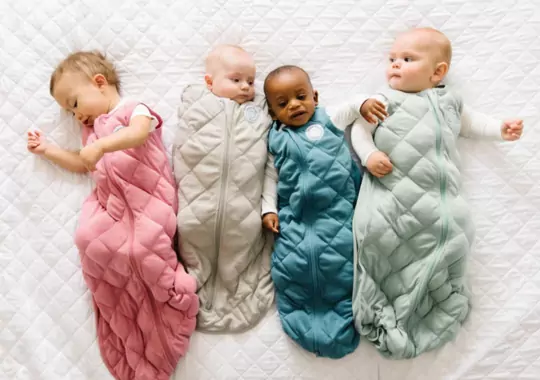 Babies wearing sleep sacks.