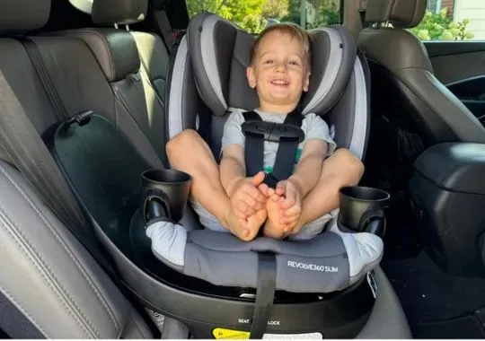 A baby seated in a rotating car seat.