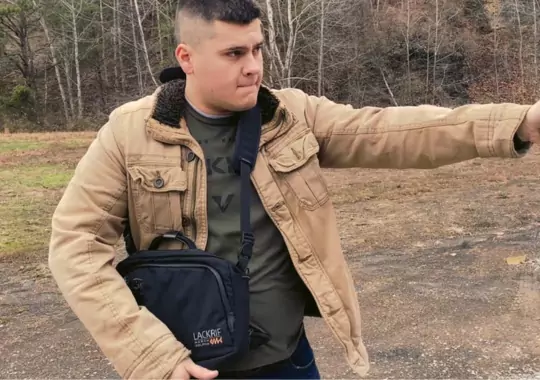 A man with a Concealed Carry purse.
