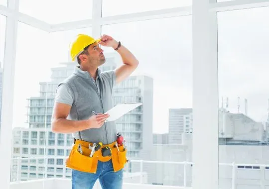 Handyman inspecting a building.