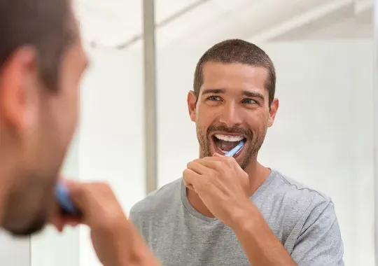 A man brushing his teeth.