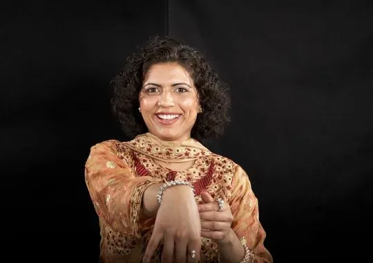 A woman showing off a bracelet.